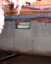 Illinois, Iowa, and Missouri crawl space with vents, showing mold, rot, and fiberglass insulation dripping off the ceiling.