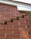 Serious damage to a foundation wall due to settlement of a home in Donnellson