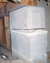 Concrete crawl space support posts in Colchester that are showing signs of failure as they sink into the earth.