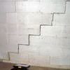 A diagonal stair step crack along the foundation wall of a Colchester home