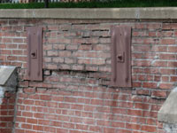 A collapsing, crumbling retaining wall in Mendon