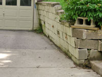 a failing retaining wall around a driveway in Quincy