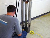 Driving foundation piers into the floor in Canton.