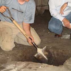 Digging a hole for the engineered fill used in a crawl space support system installation in Palmyra