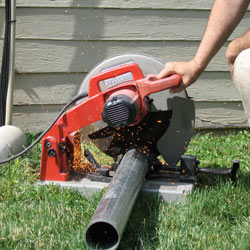 Cutting the support beam for a crawl space jack post outside a Rushville home.