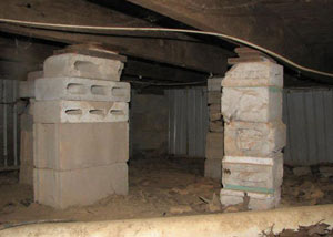 crawl space repairs done with concrete cinder blocks and wood shims in a Colchester home