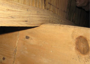 A failing girder showing signs of compression damage in a Keosauqua home