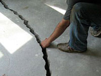 a severely damaged cracked concrete slab floor in Donnellson