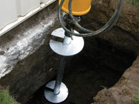 Installing a helical pier system in the earth around a foundation in Fort Madison