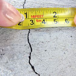A crack in a poured concrete wall that's showing a normal crack during curing in Astoria