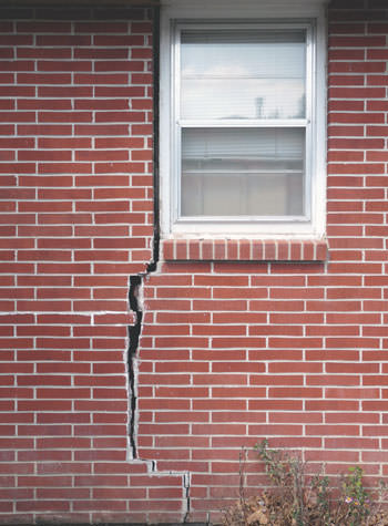 severe foundation wall cracks along a window in Elliott