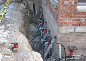 Foundation push piers installed around a house with a foundation settlement issues in Edina