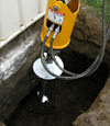 Installing a helical pier during a foundation repair in Fort Madison