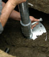Fort Madison helical pier installation nearing completion, with the blade being advanced into the foundation soils.