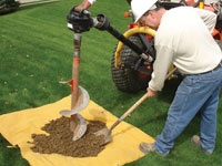 Auguring a hole in the earth for a foundation wall repair system in Rushville