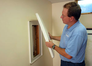 Foundation wall anchor covers installed in a finished basement with a repaired foundation wall in Edina.