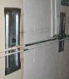 Foundation wall anchor plates installed in a basement in Kirksville