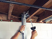 Straightening a foundation wall with the PowerBrace™ i-beam system in a West Burlington home.