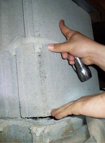a completely failing concrete crawl space support pillar in Astoria