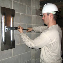 installing a wall anchor to repair an bowing foundation wall in West Burlington