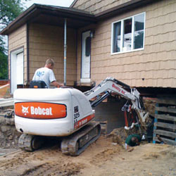 Excavating to expose the foundation walls and footings for a replacement job in Carthage