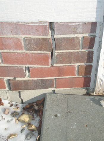 Severe street creep damage to a garage wall outside a La Harpe home