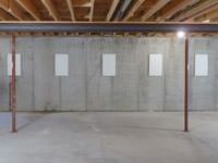 A repaired basement wall with foundation wall anchor covers installed in Mount Sterling.