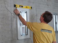 Positioning a wall plate cover on a foundation wall in Palmyra.