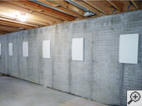 Wall anchor covers installed along a foundation wall that has been straightened in Bellflower.