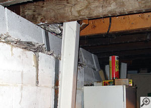 A failing foundation wall and i-beam support in a Quincy home