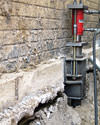 A completed installation of foundation push piers lifting a foundation in Memphis