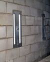 an inside view of foundation wall anchors installed along a basement wall to brace and repair the structure in Hamilton