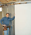 Installing wall panels on top of our basement wall insulation in Palmyra