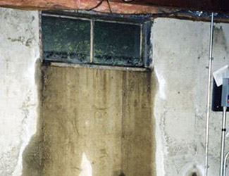 Water pouring out from a basement window in Peoria